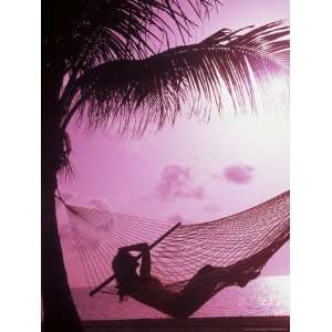  Woman Relaxing in a Hammock on the Beach at Sunset 