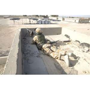 com A British soldier provides security from a rooftop in Basra, Iraq 