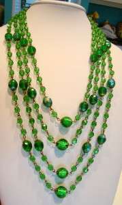 Four draping strands of green Czech glass beads, peacock green foil 