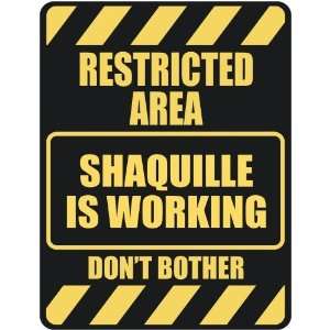  RESTRICTED AREA SHAQUILLE IS WORKING  PARKING SIGN 