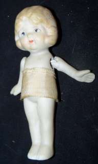 this doll has been broken and neatly repaired there is a crack beneath 