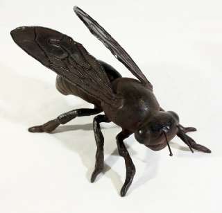   cast iron bumblebee statue makes a whimsical addition to garden decor
